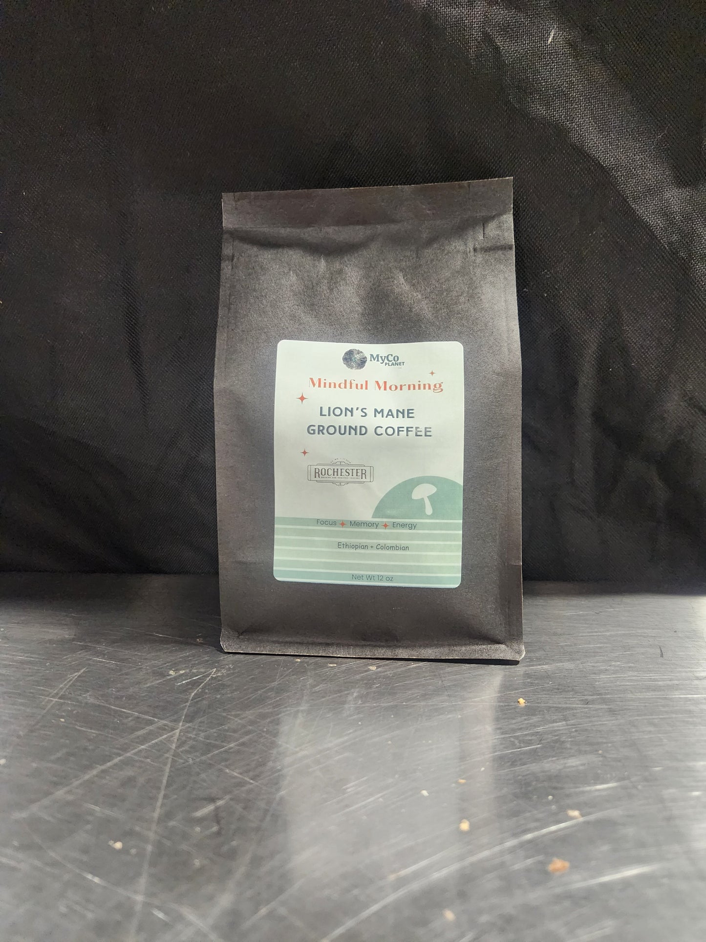 Ground Lion's Mane coffee from MyCo Planet in a clear bag, showing dark roasted beans and natural packaging.