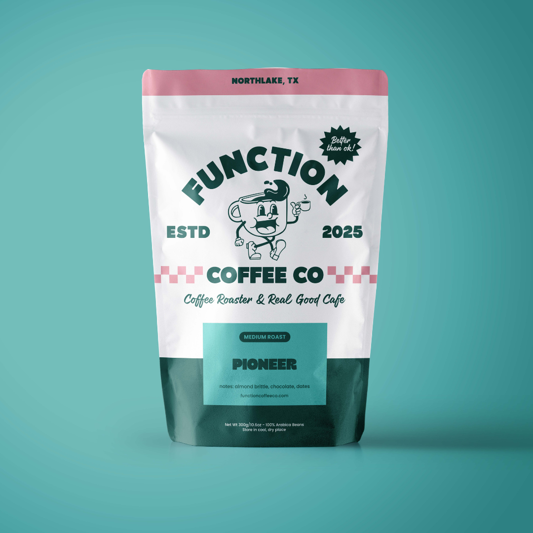 Medium roast Pioneer coffee beans by Function Coffee Co, featuring rich brown roasted coffee beans in a natural setting