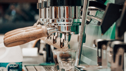 stainless steel coffee press on glass table