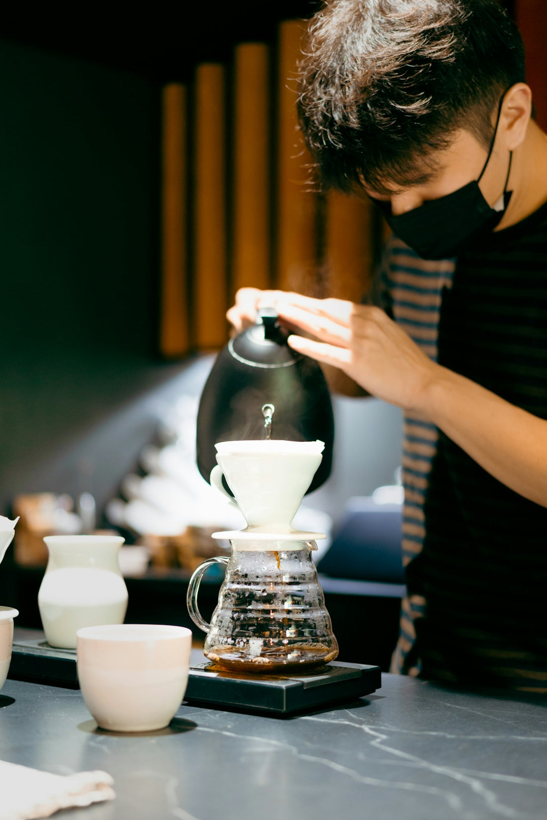a person sitting at a table with a cup of coffee