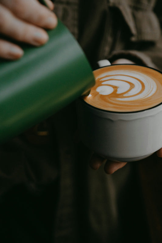 a person holding a cup of coffee in their hands