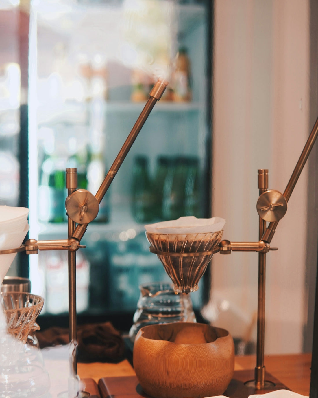 a couple of coffee grinders sitting on top of a wooden table
