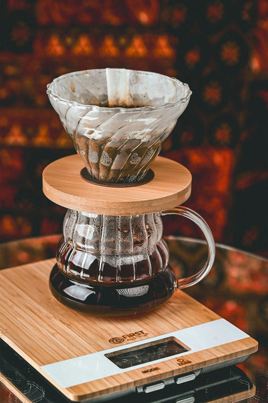 A coffee pot sitting on top of a scale
