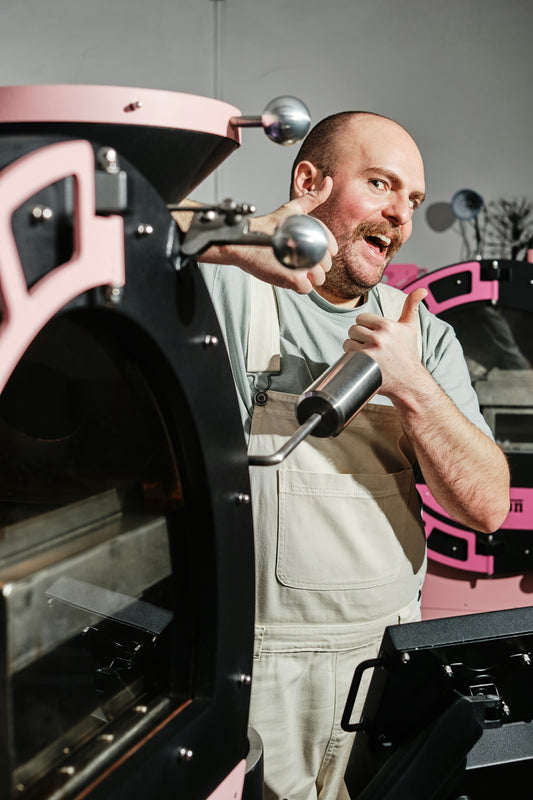 A man standing in front of a pink oven