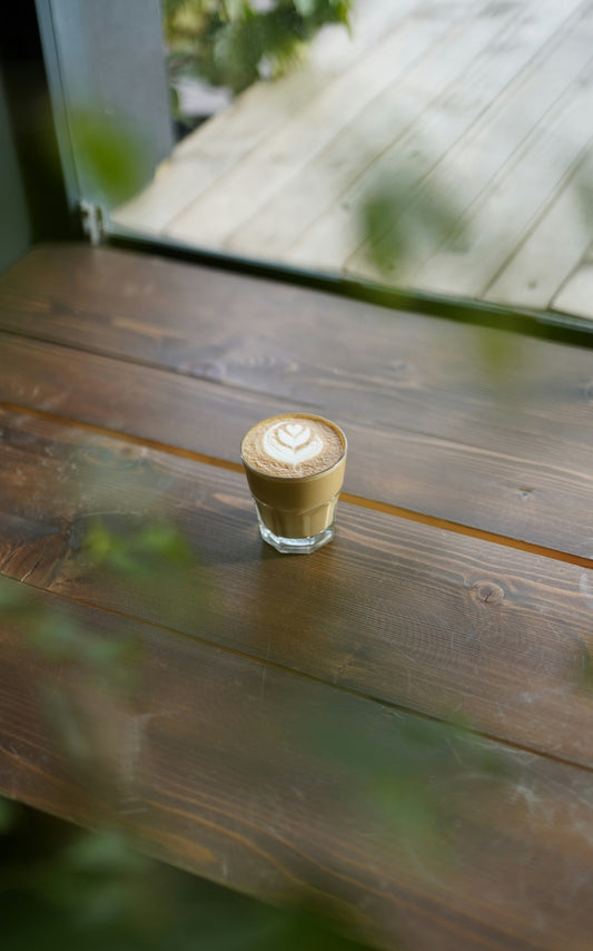 Latte with art on a wooden table