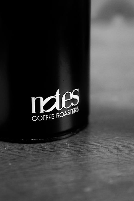 A black container with notes coffee roasters logo.