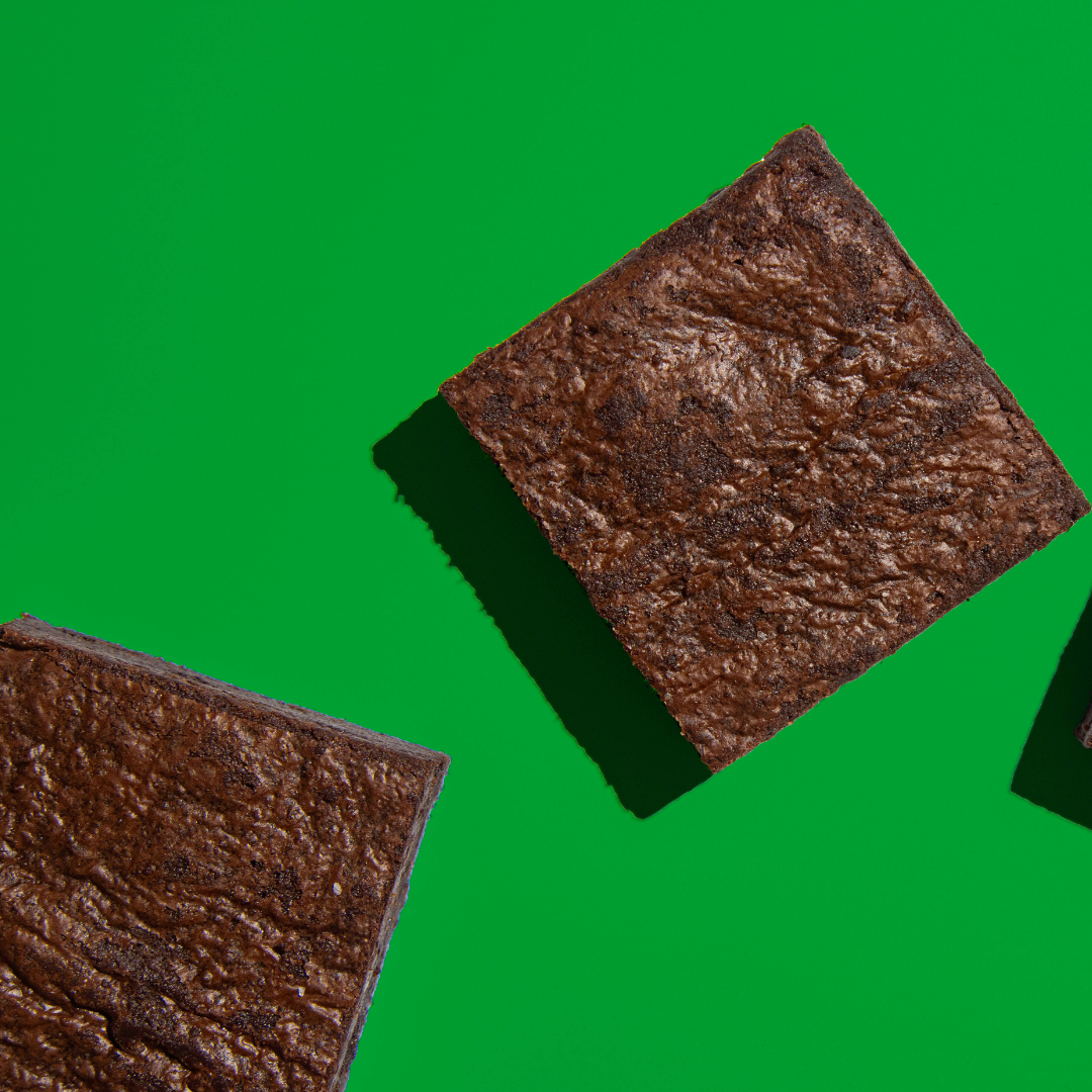 Six rich coffee-flavored brownies from eatruani arranged on a plate, showcasing their moist, chocolatey texture.