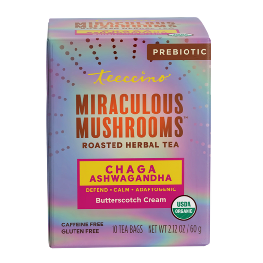 Herbal tea by Teeccino featuring Chaga, Ashwagandha, and butterscotch cream flavor in a tea cup with dried herbs and mushrooms.