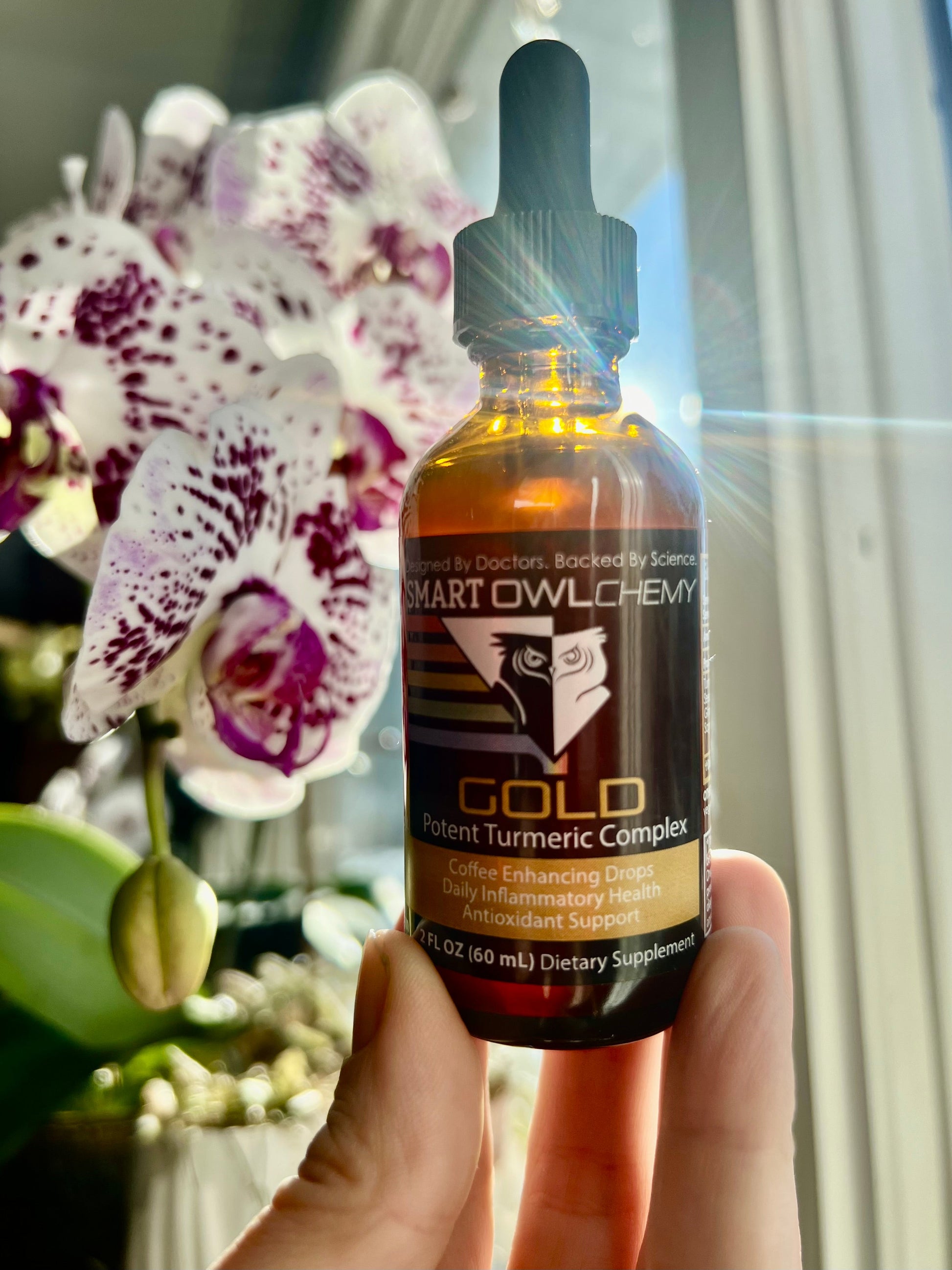 Smart Owl Coffee GOLD DROPS Smart OWLchemy turmeric supplement drop in a small 2oz bottle with dropper cap.