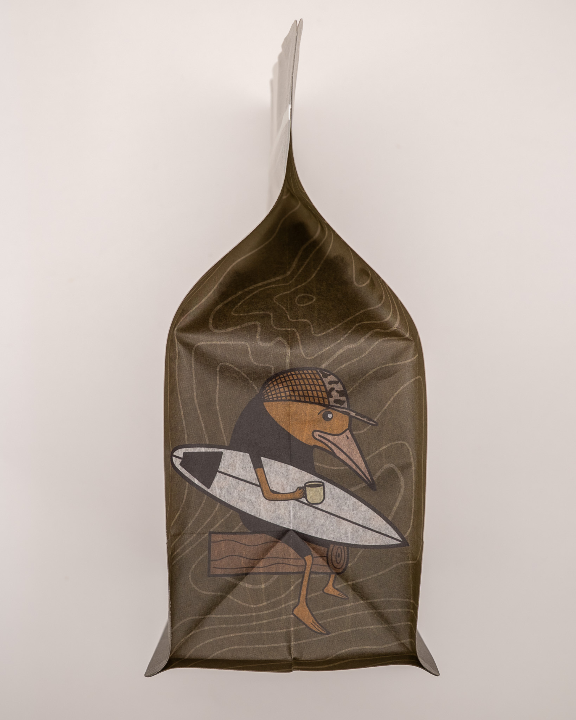 Sad Bird Coffee FIRST LIGHT Half Caff Medium Roast coffee bag with label and branding visible.