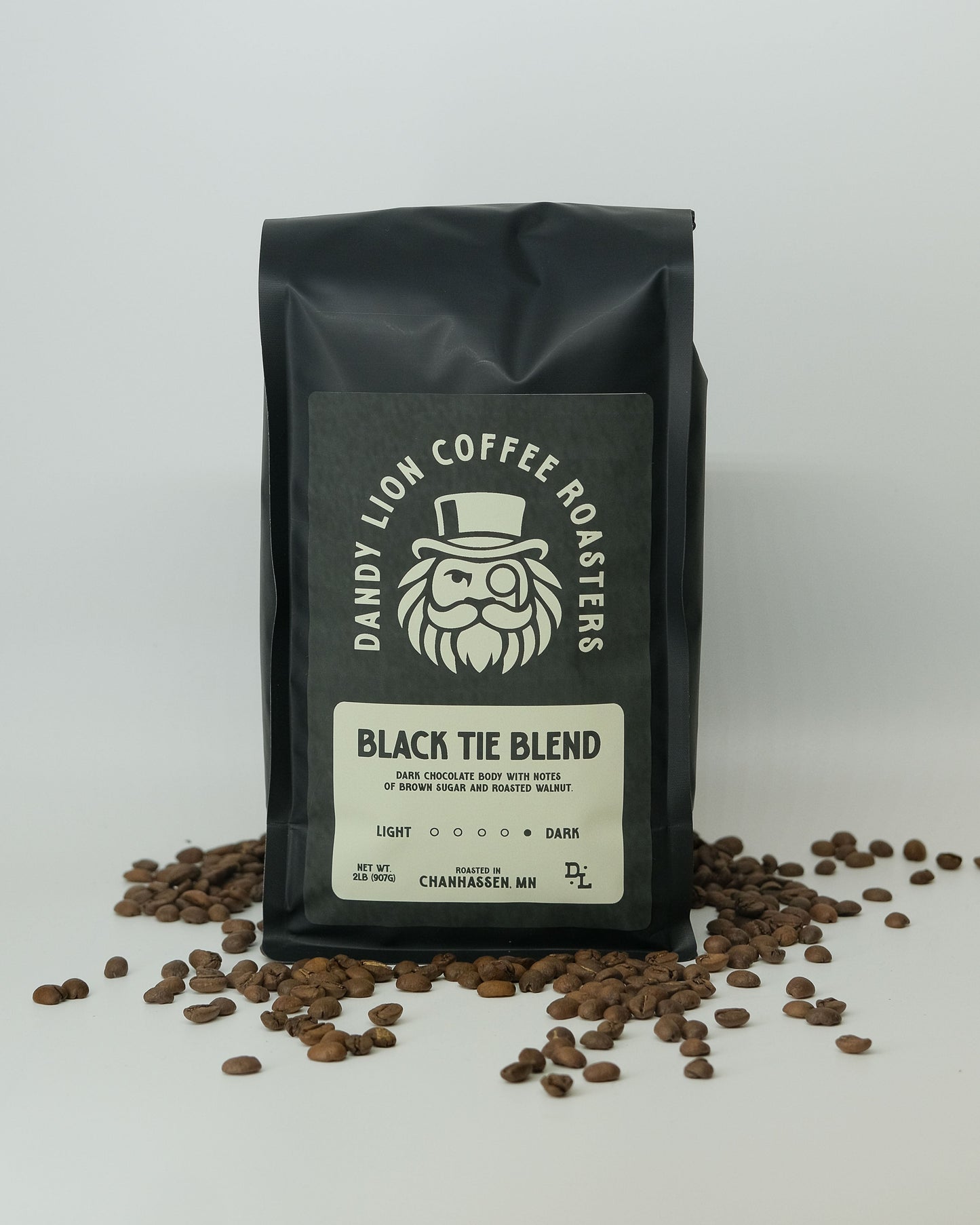 Black Tie Blend coffee beans from Dandy Lion Coffee in a resealable bag with a black and gold label.