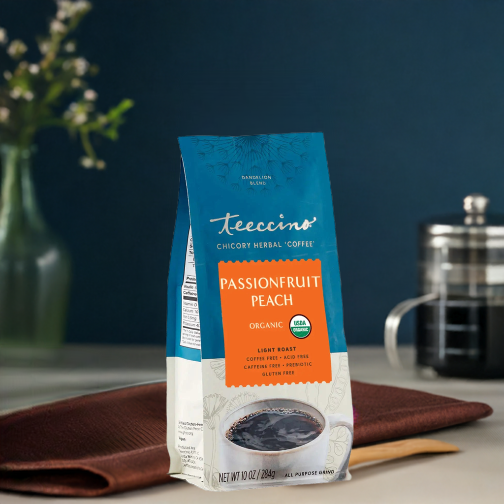 Dandelion Passionfruit Peach Herbal Coffee by Teeccino in a brewed cup with herbal coffee blend and fresh fruit slices.