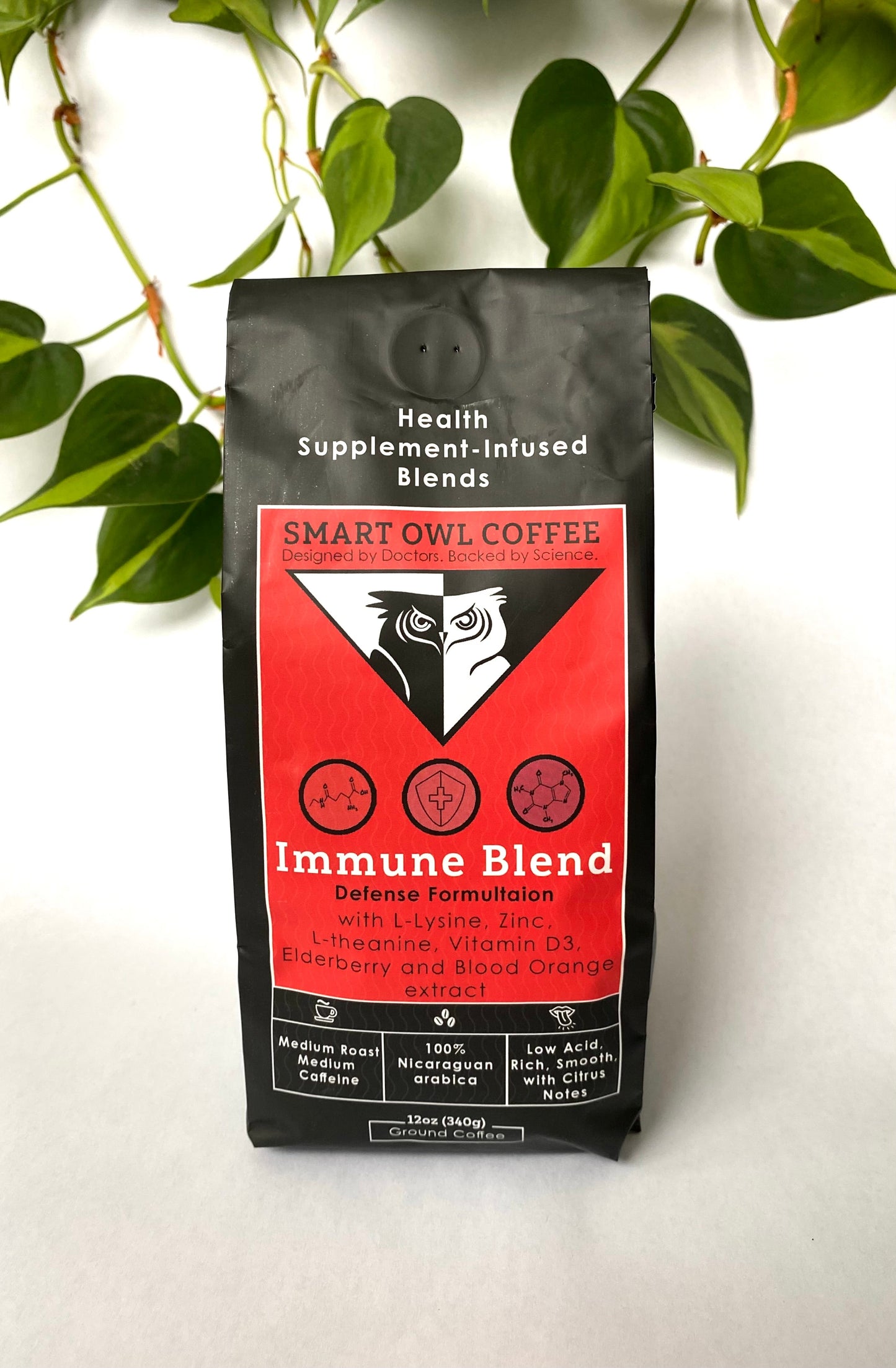 Smart Owl Coffee immune blend coffee cup with coffee beans and a cozy background, showcasing the Immunity Blend packaging.
