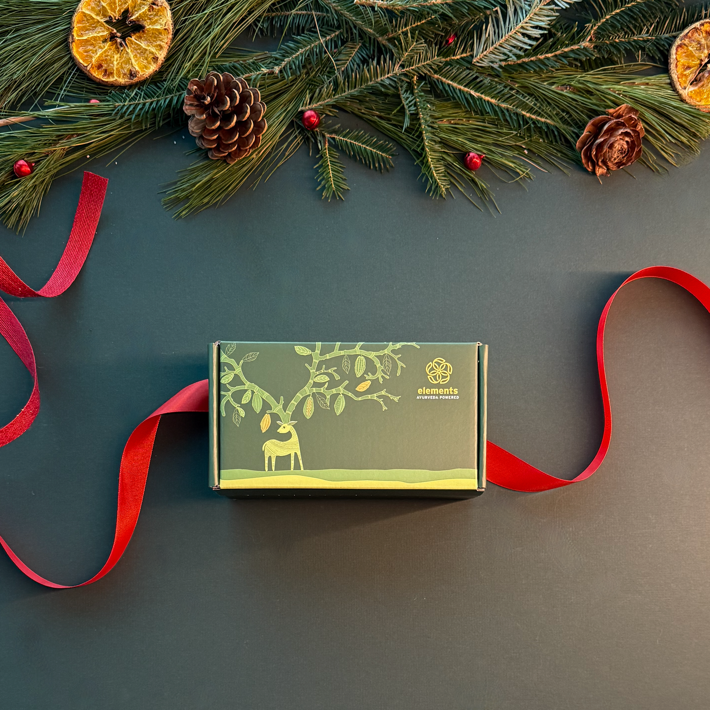 Assorted Elements Truffles chocolates from The Soma Collection displayed in a decorative box with smooth, glossy surfaces and elegant packaging.