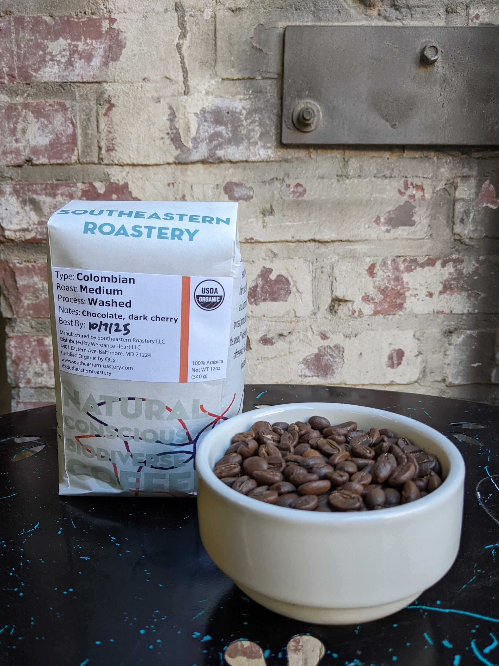 Benevolent Bean Grow To Market 12oz organic Colombian coffee bag with fresh roasted beans in a natural setting