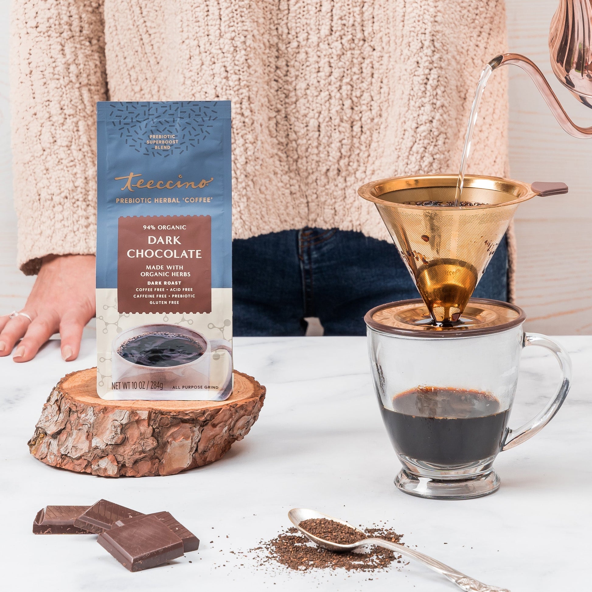 Herbal coffee cup featuring dark chocolate flavor from Teeccino's prebiotic superboost herbal coffee on a wooden surface.