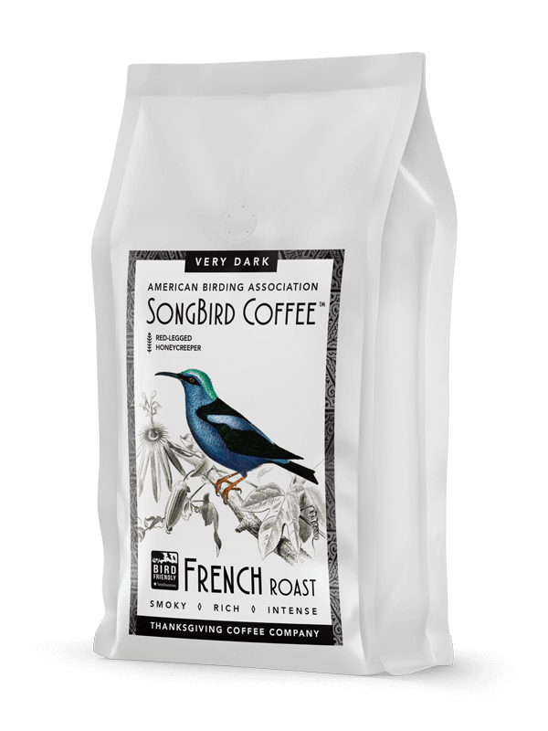 Dark roast coffee beans from SongBird French blend by Thanksgiving Coffee Company, shown in a close-up image.