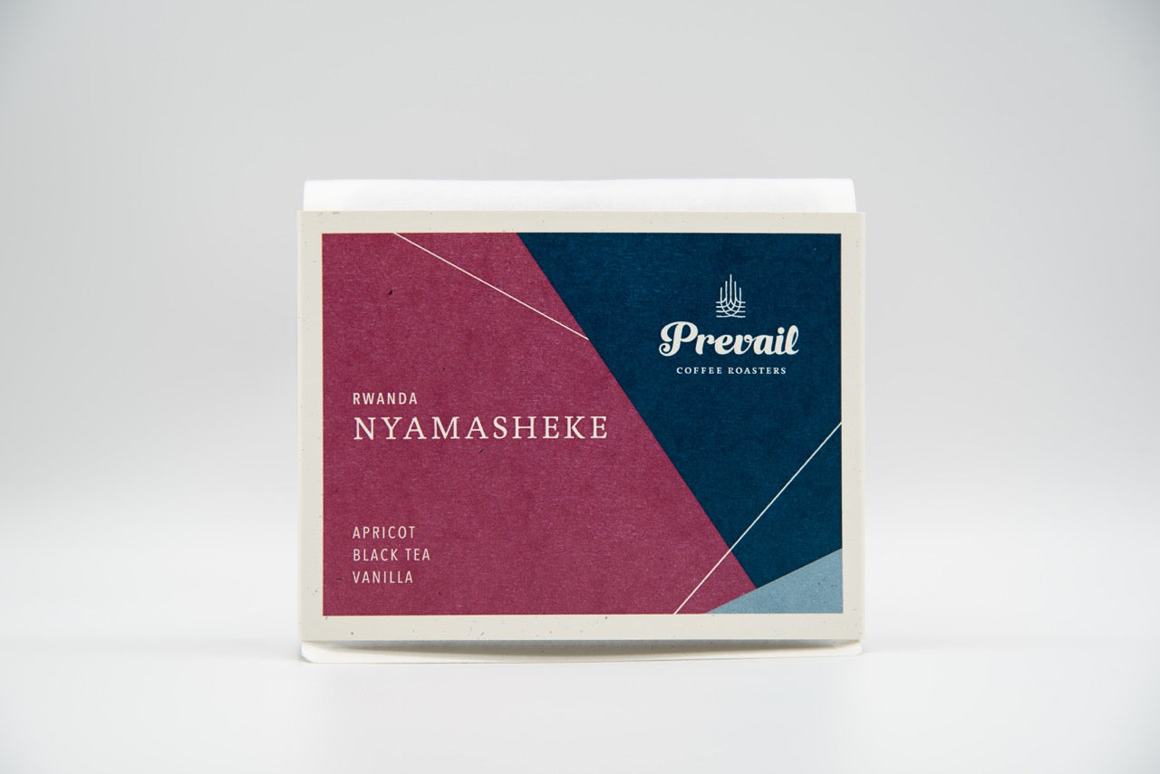 Fresh brewed Rwanda Nyamasheke coffee from Prevail Coffee in a ceramic cup with steam rising.