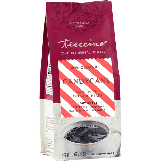Teeccino Candy Cane Chicory Herbal Coffee in a clear glass mug with candy cane garnish, showcasing festive herbal coffee.