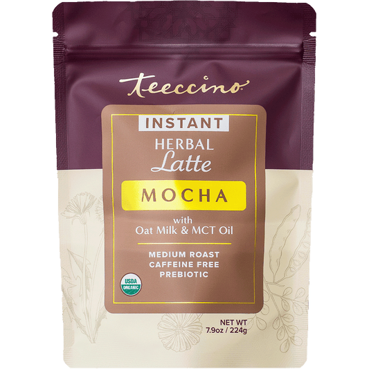 Teeccino instant mocha herbal latte in a cup, showcasing rich mocha flavor with herbal ingredients, front view on a white background.