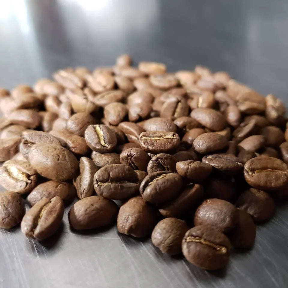 Iron Bean Coffee Company Cast Iron™ Medium Roast coffee bag with label and branding visible.