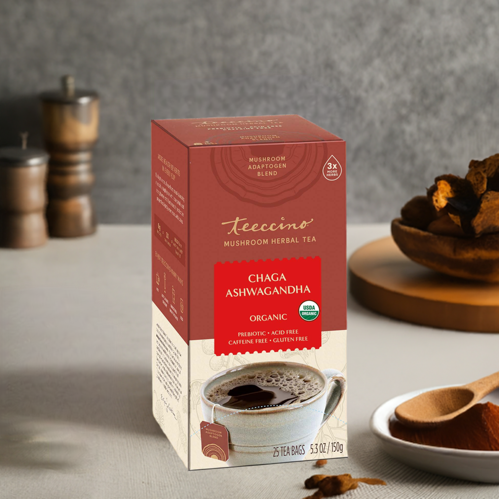 Herbal tea by Teeccino featuring Chaga, Ashwagandha, and butterscotch cream flavors in a steaming cup with tea leaves and herbs.