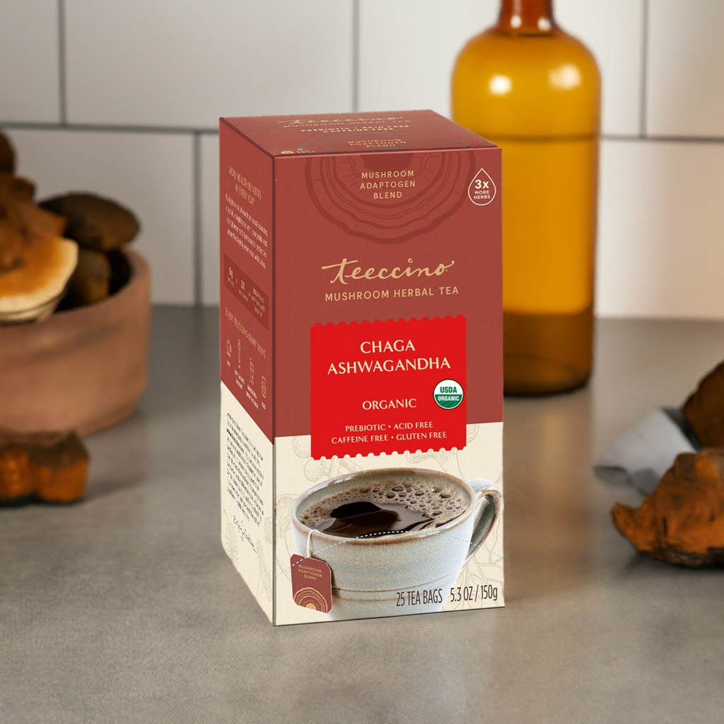 Herbal tea by Teeccino featuring Chaga, Ashwagandha, and butterscotch cream flavors, displayed in a cup with tea leaves and herbs.