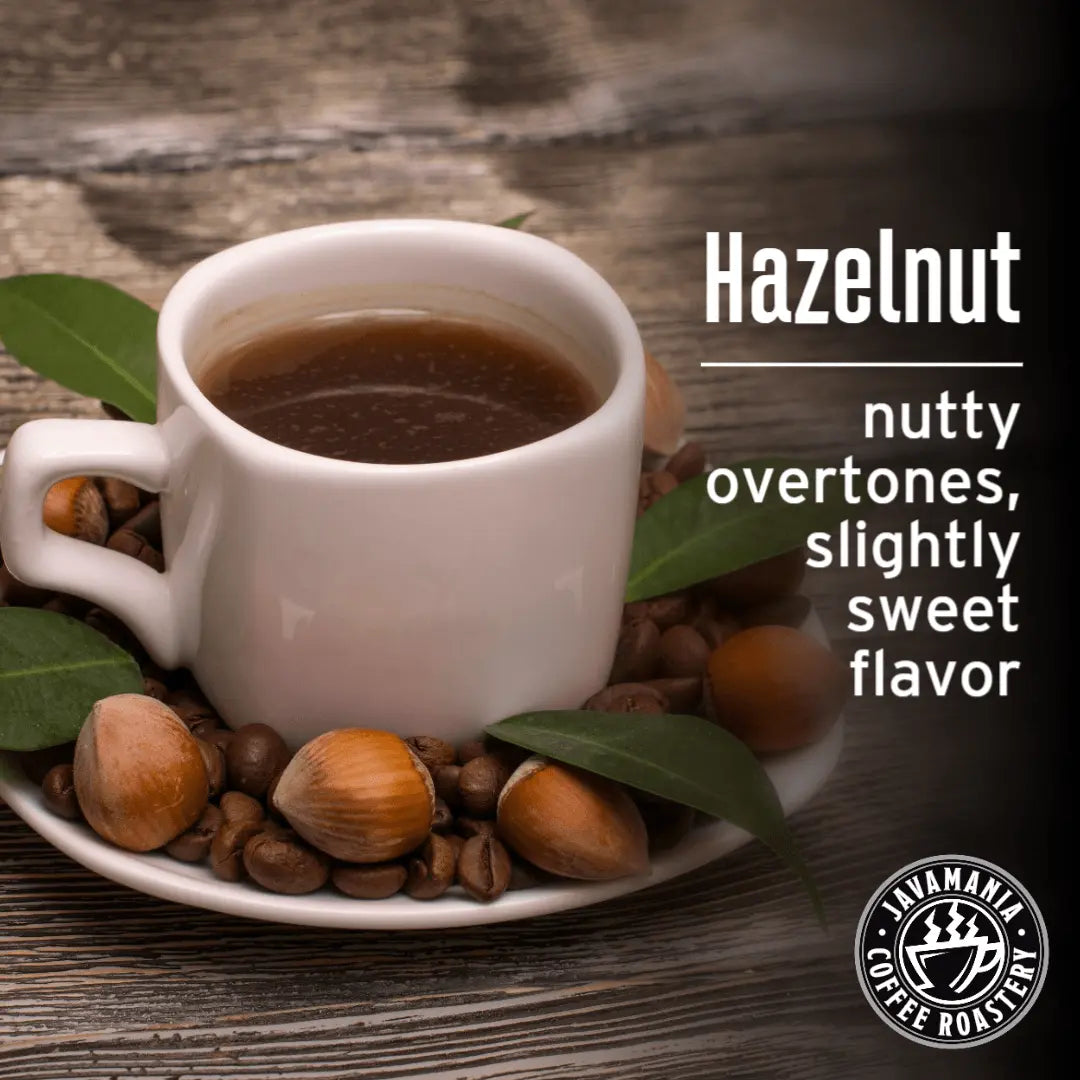 JavaMania hazelnut flavored coffee in a bag with whole hazelnuts and coffee beans on a rustic wooden surface.