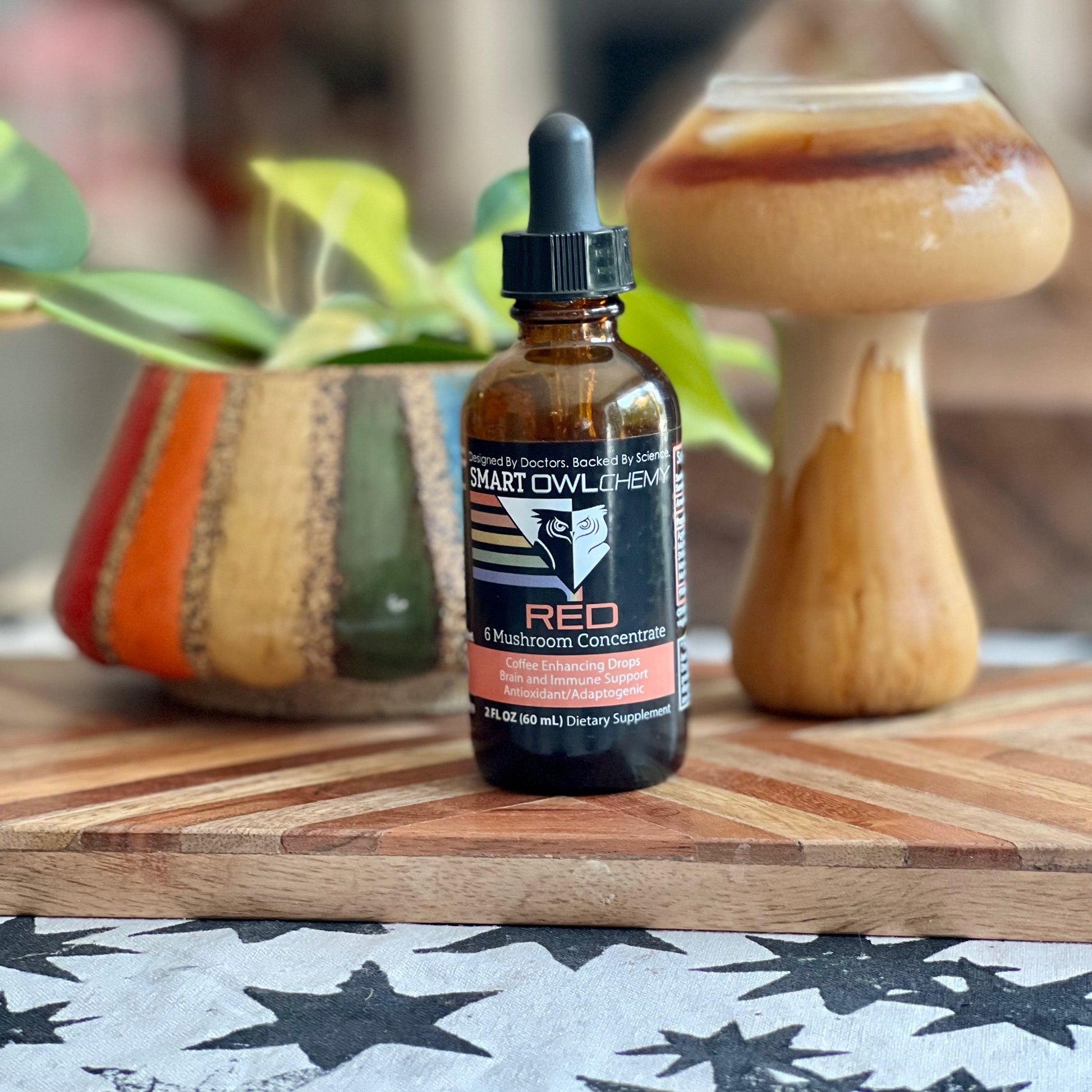 Red Drops Smart Owlchemy mushroom extract supplement drop in a small glass bottle with dropper, designed for health support.