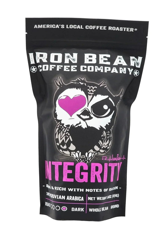 Dark roast coffee labeled Integrity™ by Iron Bean Coffee Company in a bag with branding and product details visible.