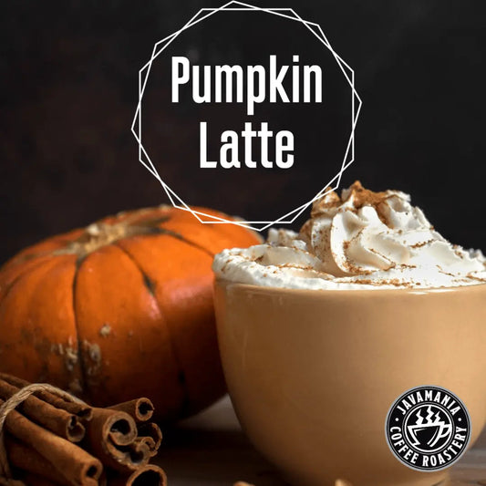 Creamy pumpkin latte from JavaMania, topped with whipped cream and spices in a clear glass mug. Perfect for fall mornings.