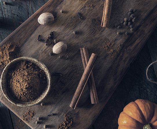 Stone Street Pumpkin Spice Coffee with cinnamon sticks, ground coffee, spices, and pumpkin