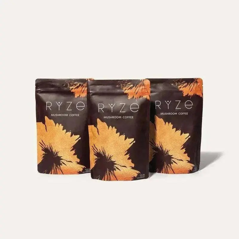 Pack of three Nutragole RYZE Mushroom Coffee jars with organic instant coffee, MCT oil, and adaptogenic mushrooms including Lion's Mane and Reishi.