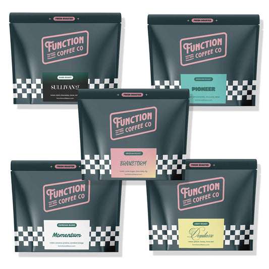 Assorted coffee sampler box from Function Coffee Co featuring various roasts and blends in a sleek packaging display.