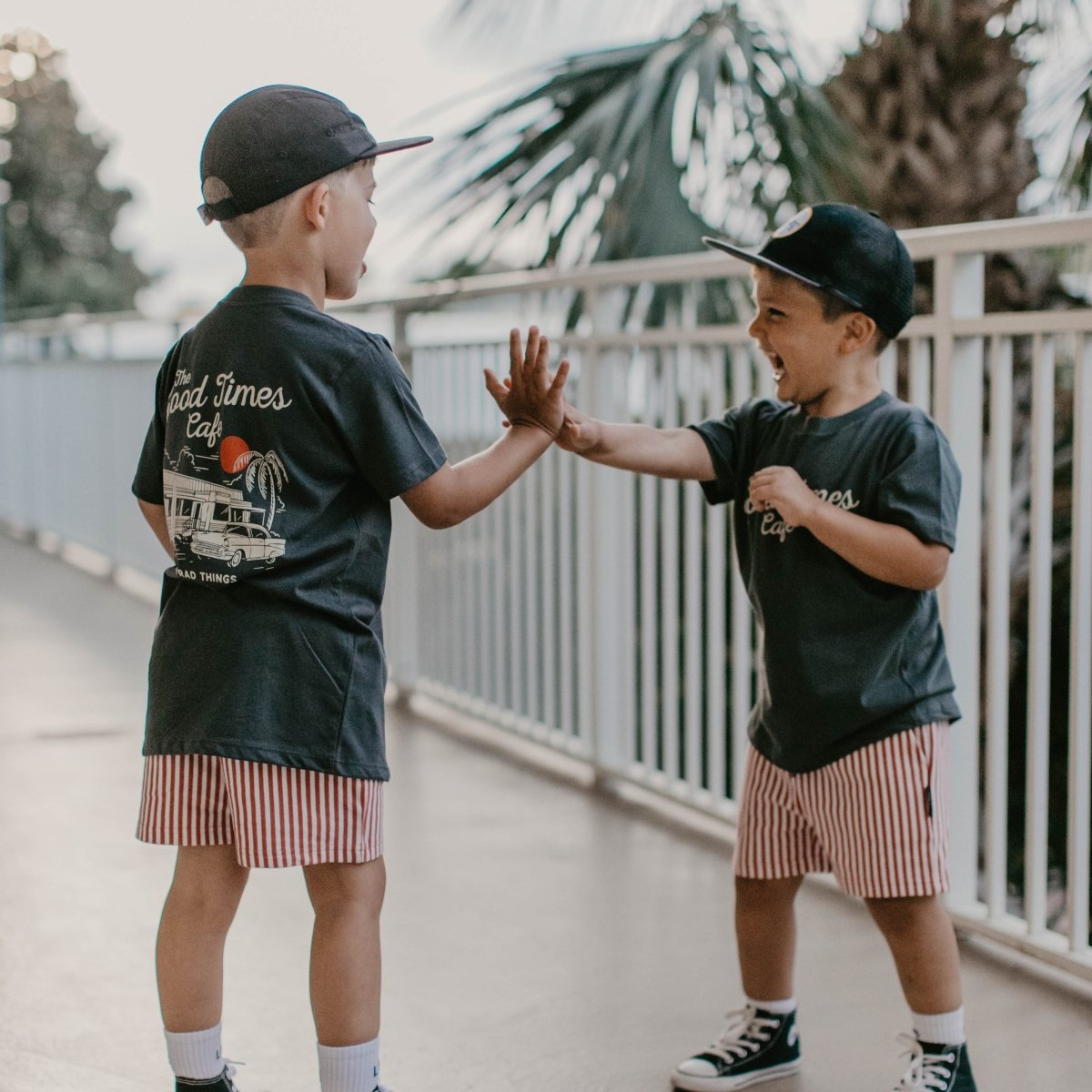 Baby toddler top by Little Rad Things featuring "The Good Times Cafe" design in coal color. Cozy and stylish for little ones.