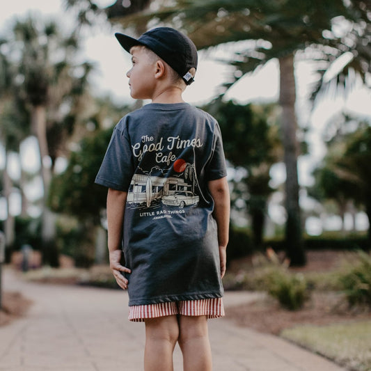 Baby boy wearing THE GOOD TIMES CAFE TEE in coal color from LITTLE RAD THINGS, featuring a casual toddler top with playful design.