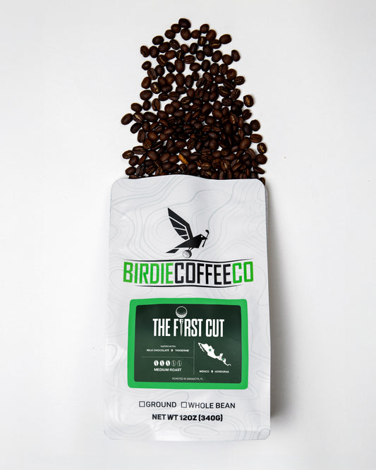 Medium roast coffee beans from Birdie Coffee Company's The First Cut, showcasing a close-up of freshly ground coffee.